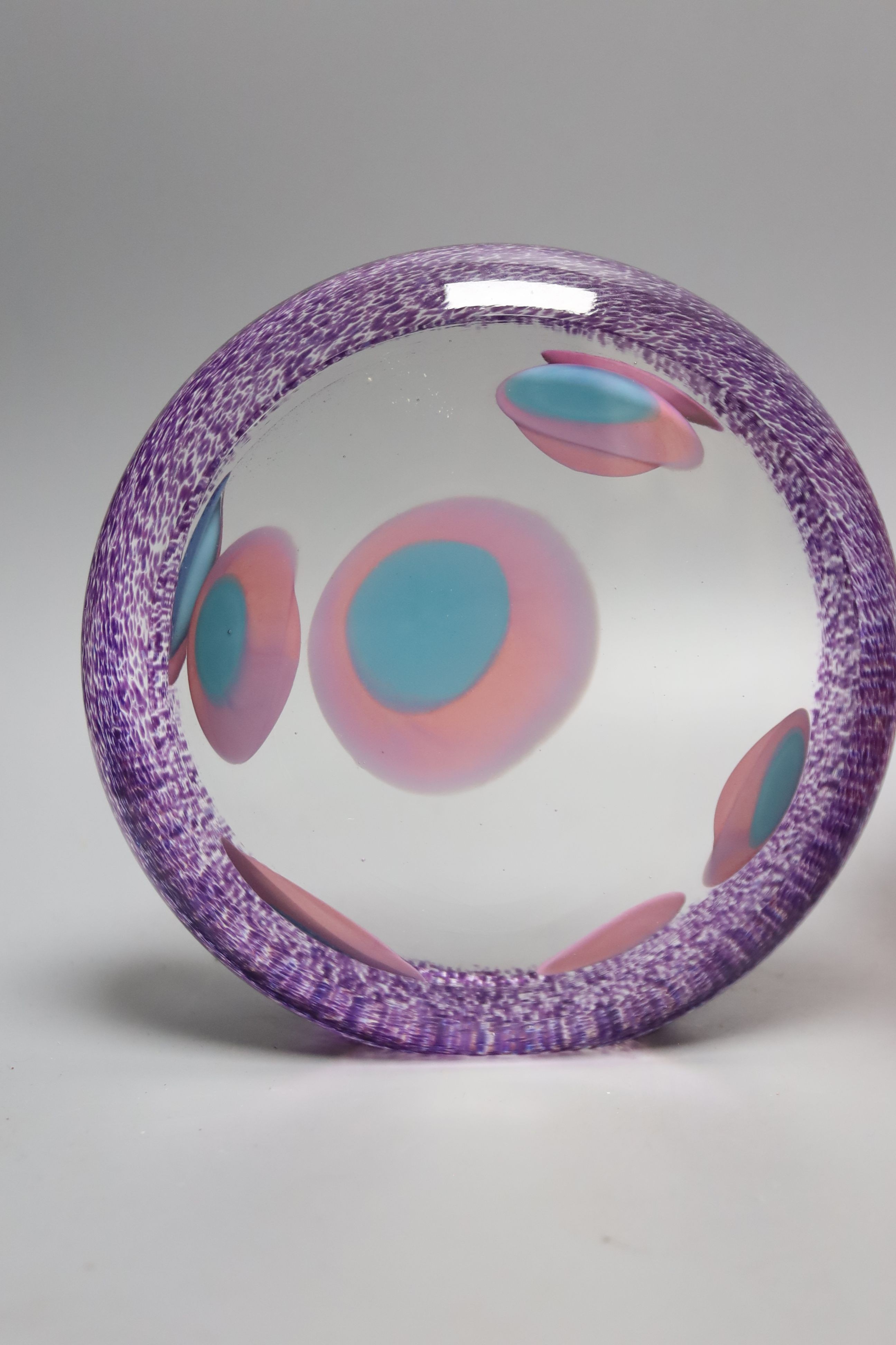 Two Jane Charles art glass disc panels and a pink art glass bowl, tallest 15.5cm